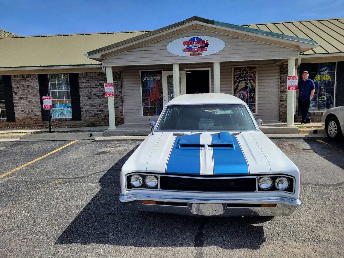 The Great Scott's storefront on Winchester Rd with a classic car out front